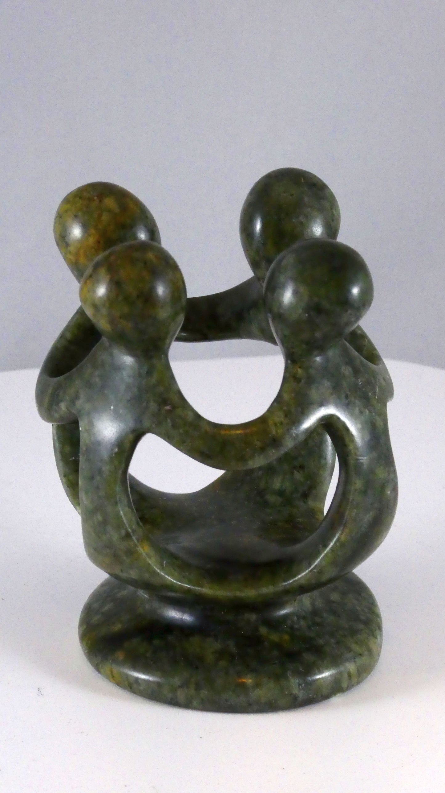 Stenen beeld, groep van 4 personen, 10 cm hoog, volledig glad afgewerkt